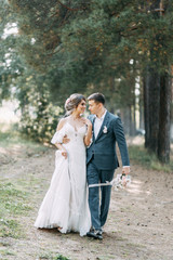 Stylish European wedding at sunset. Happy couple in the forest in nature.