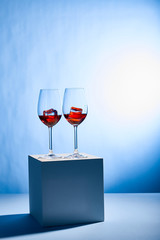 cocktails Aperol Spritz with ice cubes in glasses on blue background