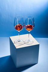 cocktails Aperol Spritz with ice cubes in glasses on blue background