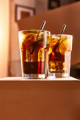 cocktails cuba libre in glasses with straws on cube