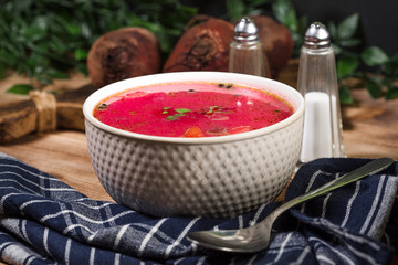 Red borscht soup in bowl.