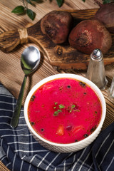 Red borscht soup in bowl.