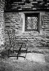 Iron bench and church window monochrome