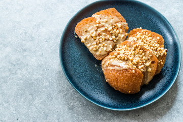 Turkish Dessert Hayrabolu with Sherbet, Tahin, Cheese and Hazelnut Powder.