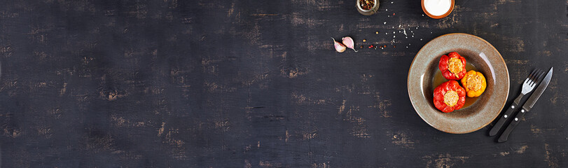 Colorful stuffed peppers with rice and minced meat on wooden background. Top view. Banner