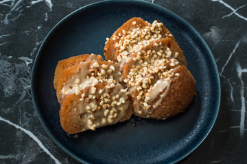 Turkish Dessert Hayrabolu with Sherbet, Tahin, Cheese and Hazelnut Powder.