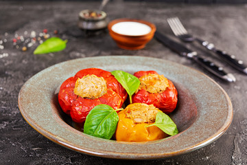 Colorful stuffed peppers with rice and minced meat on wooden background.