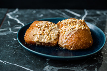 Turkish Dessert Hayrabolu with Sherbet, Tahin, Cheese and Hazelnut Powder.