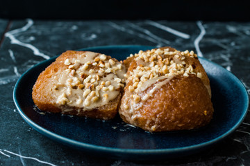 Turkish Dessert Hayrabolu with Sherbet, Tahin, Cheese and Hazelnut Powder.
