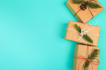 Christmas border. Christmas gifts, fir branches on color background. Flat lay, top view, copy space - Image