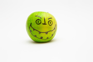 Smiley face. Apples drawn on the face. Apples on white background.