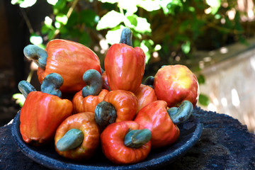 Cashew nuts isolated with glass of fruit juice on white background.