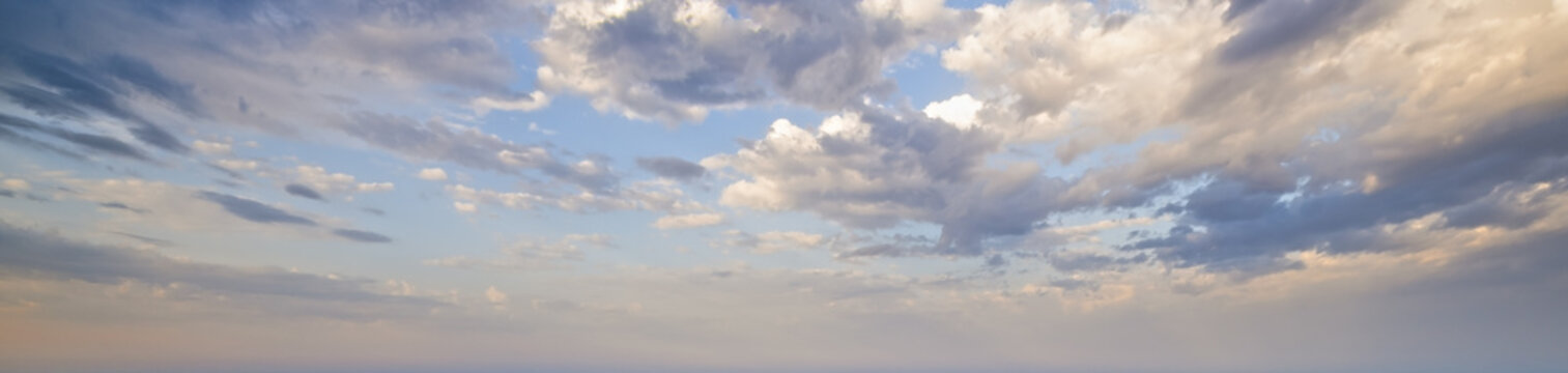 Blue morning sky with clouds (wide background panorama). © wildman
