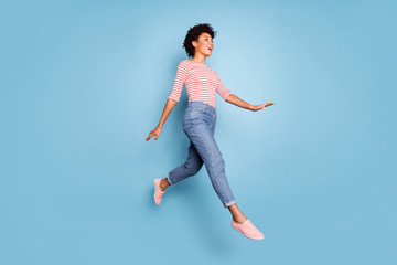 Full length profile side photo of excited cheerful afro american jump go walk having rest relax...