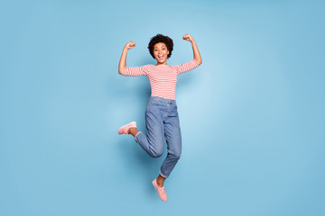 Fototapeta na wymiar Full length body size photo of cheerful positive cute nice pretty sweet girlfriend wearing jeans denim striped shirt footwear jumping isolated pastel blue color background