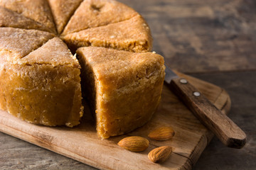 Traditional Christmas marzipan slice on wooden table. 