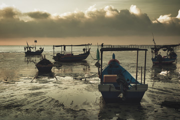 haphazard moored boats at low tide