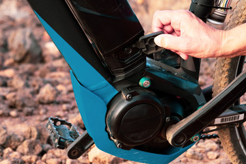 Close up of the motor and battery of a black e bike. Outdoor activity with bicycle for healty lifestyle