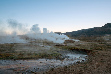 Fototapeta na wymiar Geothermal area in Icelandic nature. Smoke and sulfur smell.