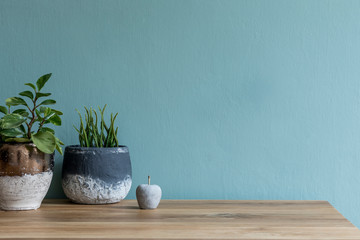 Stylish and design composition of home decor on living room with plants in different pots, cement...