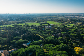 Fototapeta na wymiar Aerial view of ancient Via Appia Antica with green trees, meadows, houses and pathways in Rome, Italy.