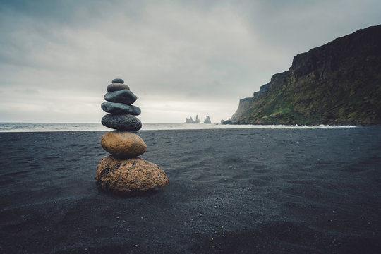 Stones on lava sand beach in Iceland.