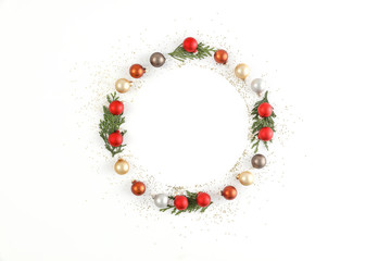 Minimalist composition on a white background. Christmas decorations, place for your product. Flat lay, Copy spay, Winter time. December background of winter. Fir branches.