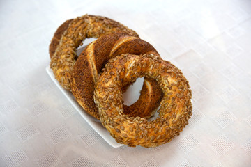 bagels next to each other on white plate, on white tablecloth