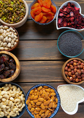 nuts, seeds and dried fruis on wooden surface