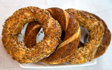 bagels next to each other on white plate, on white tablecloth
