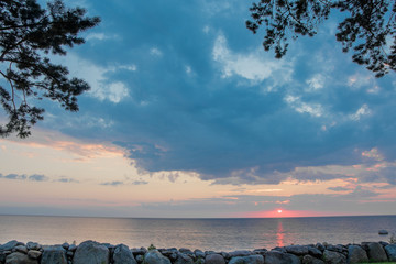 Beautiful sunset on the stone coast of the Gulf of Riga of the Baltic Sea. Near the village of Kabli, Estonia.
