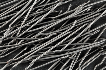 Extreme close up, top down view of end hooked steel macro fibers for concrete reinforcement....