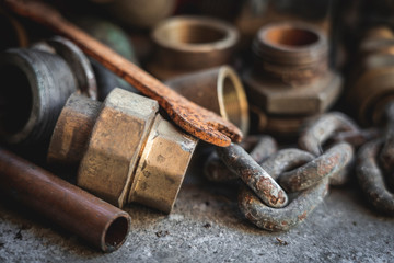 Old pipes, parts, rusty wrench. Garage and vintage, retro concept.