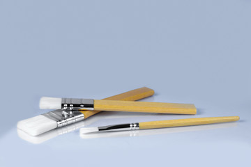 Paint brushes on gray background, front view