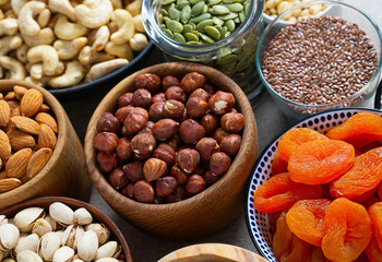 fresh nuts and dried fruis on granite surface
