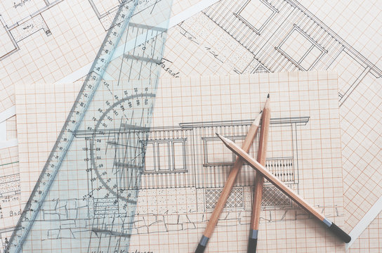 Pencils, ruler and drawings of cabin on table. Idea, architecture, drawings, cabin, bulding concepts.