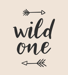 Wild one lettering with hand drawn tribal arrows. Modern brush calligraphy. Design element for kids posters, wall art, clothing. 