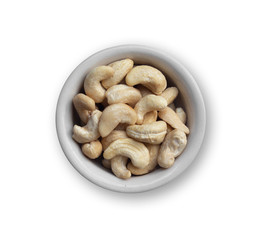 Fototapeta premium cashew nuts in a round white ceramic bowl isolated on white background with clipping path
