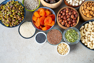 fresh nuts and dried fruis on granite surface