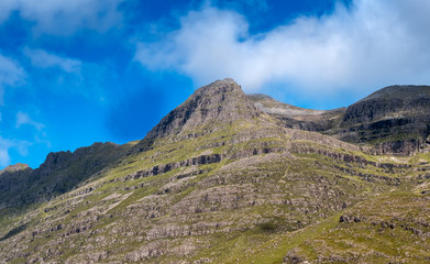 Hiking the Torridon Hills, made of some of the oldest rocks in the world and among the most spectacular peaks in the British Isles. Highlands of Scotland.