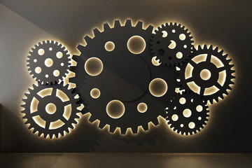background with black gears on wall