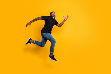 Fototapeta na wymiar Full size profile side photo of funky crazy afro american guy jump go run after black friday discounts wear stylish trendy clothing isolated over yellow color background