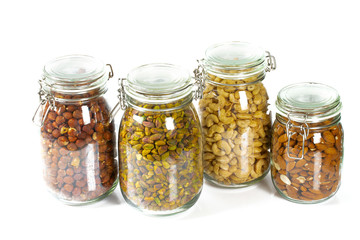 nuts in glass jars isolated on white