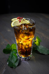 whiskey and cola cocktail with lemon