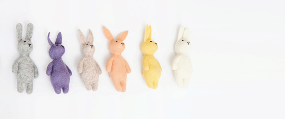 Wallow. Multi-colored hares lie on a light blue background