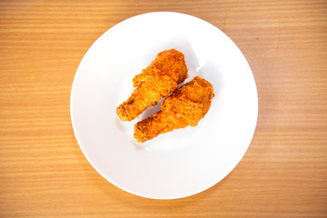 Delicious chicken fried is placed in white dish on a wood table, good for healthy food