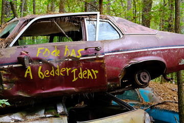 Words in Yellow Paint on a Junk Car