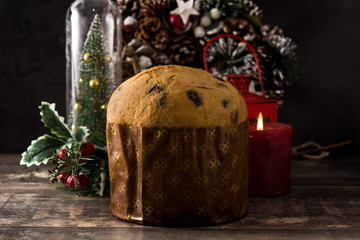 Christmas chocolate panettone cake with christmas decorated on wooden table.	