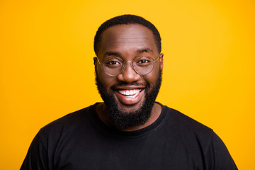 Close up photo of cheerful positive attractive black man with whitened teeth looking at you with smile on face isolated vivid color background