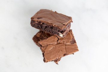 brownies chocolate three stacked on white background extreme close up
